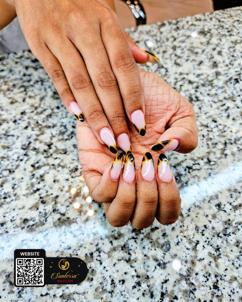 Pink almond nails with gold details by Sunterra Nails & Spa