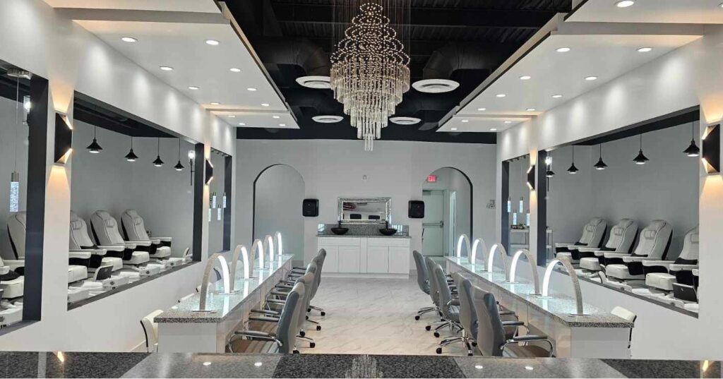 Bright manicure stations and chandelier inside Sunterra Nails & Spa in Katy