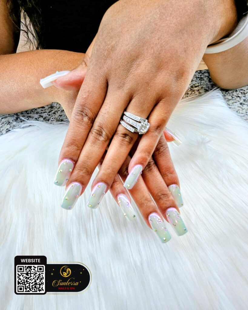 Soft green and white French nail design by Sunterra Nails & Spa